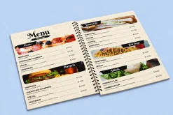 Menu mở phẳng có gáy lò xo ở giữa, trình bày hình món ăn và giá tham khảo.
